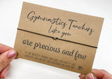 a hand holding a card that says gymnastics teachers like you are precious and few